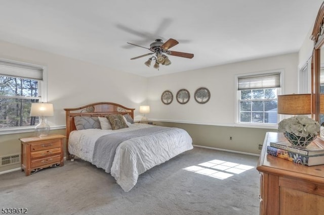 bedroom featuring light carpet, multiple windows, and visible vents