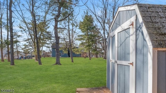 view of yard with an outbuilding and a shed