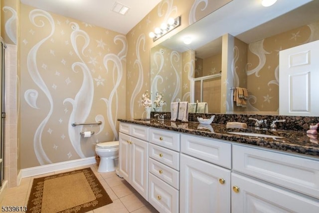 full bath with a shower with door, double vanity, a sink, tile patterned flooring, and baseboards