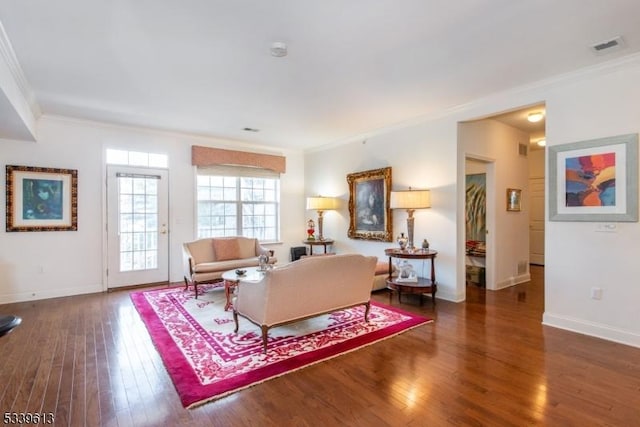 living room with baseboards, visible vents, ornamental molding, and dark wood finished floors