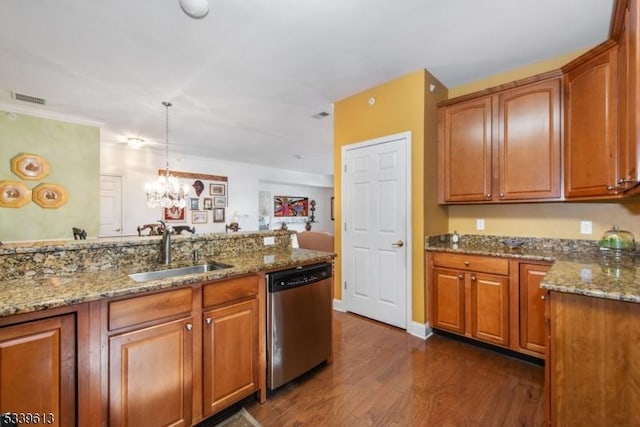 kitchen with visible vents, brown cabinetry, dishwasher, pendant lighting, and a sink