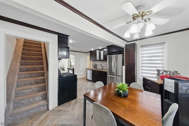 dining space with ornamental molding, stairway, and a ceiling fan