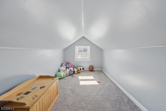 recreation room with baseboards, vaulted ceiling, and carpet flooring