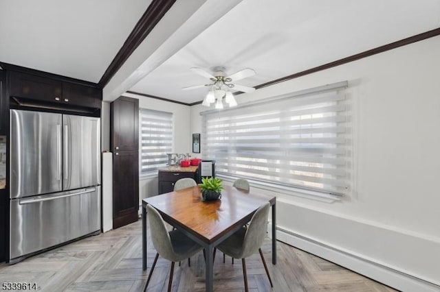 dining room featuring ceiling fan, ornamental molding, and baseboard heating