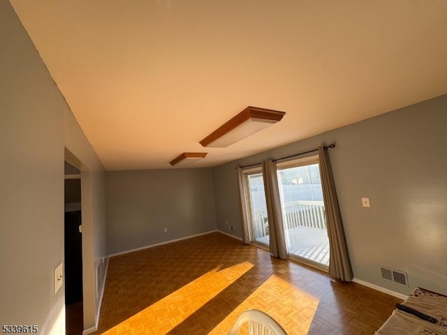 unfurnished living room featuring visible vents and baseboards