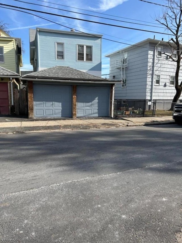 view of home's exterior featuring fence and an attached garage