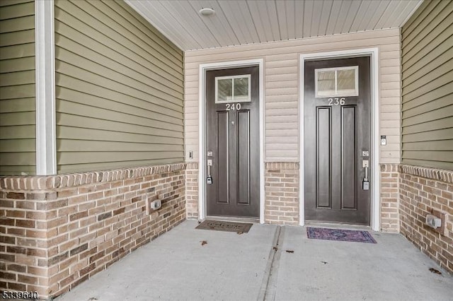 entrance to property with brick siding