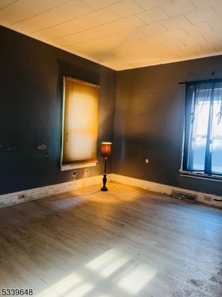 spare room featuring wood finished floors