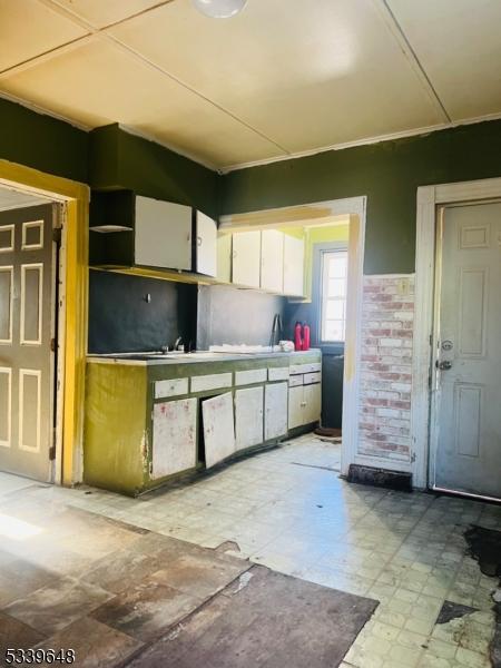 kitchen with white cabinets and tile patterned floors