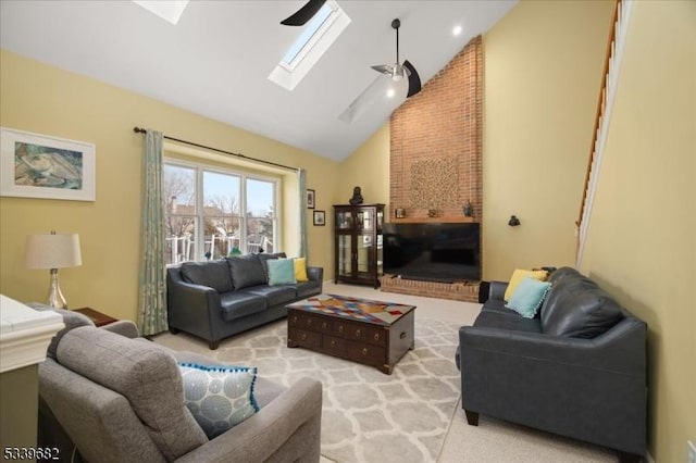 carpeted living room with a skylight and high vaulted ceiling