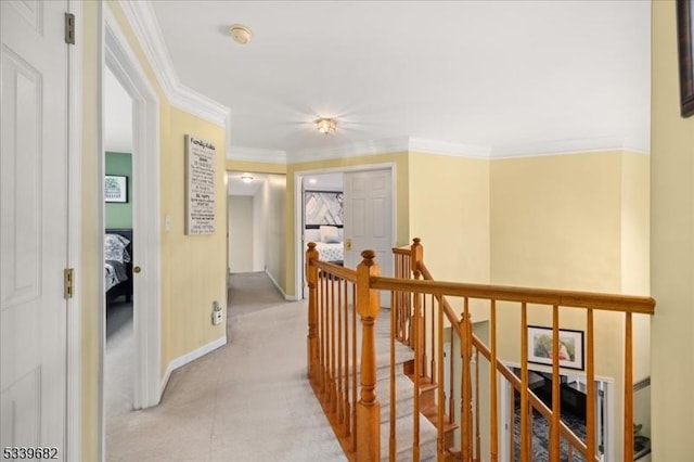 hall with ornamental molding, an upstairs landing, and baseboards