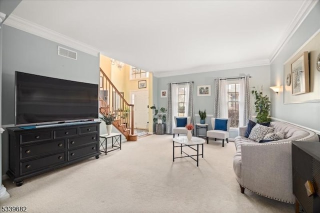 living room featuring stairs, ornamental molding, visible vents, and light colored carpet