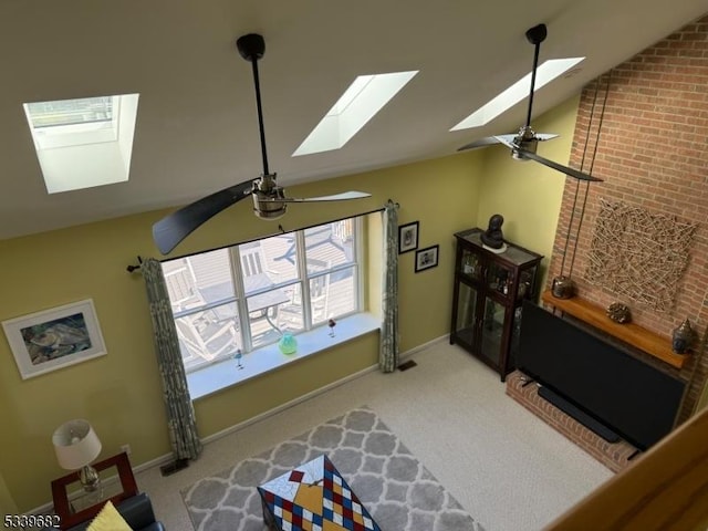 living room with a ceiling fan, vaulted ceiling, and carpet floors