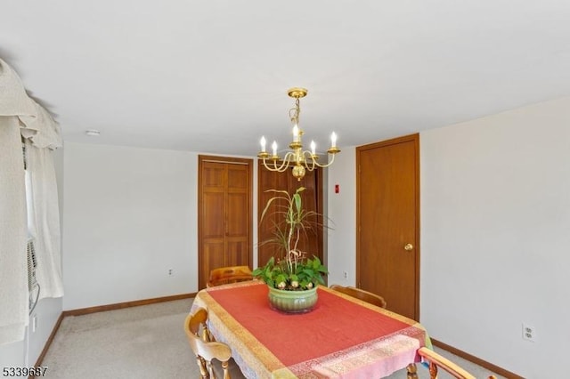 dining room featuring light carpet, an inviting chandelier, and baseboards