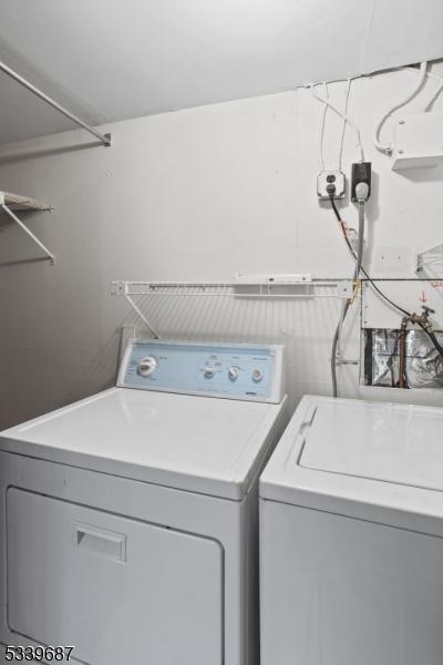 clothes washing area with laundry area and separate washer and dryer