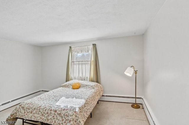 carpeted bedroom featuring baseboards, baseboard heating, and a textured ceiling