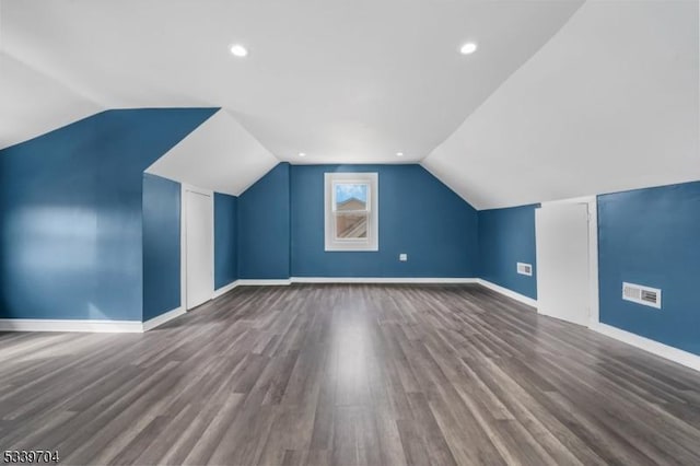 additional living space with recessed lighting, vaulted ceiling, baseboards, and wood finished floors