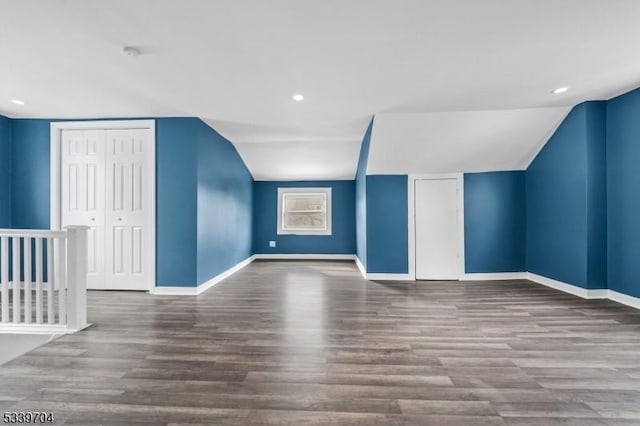 additional living space featuring lofted ceiling, recessed lighting, baseboards, and wood finished floors