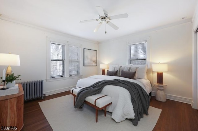 bedroom with baseboards, radiator heating unit, dark wood finished floors, and crown molding