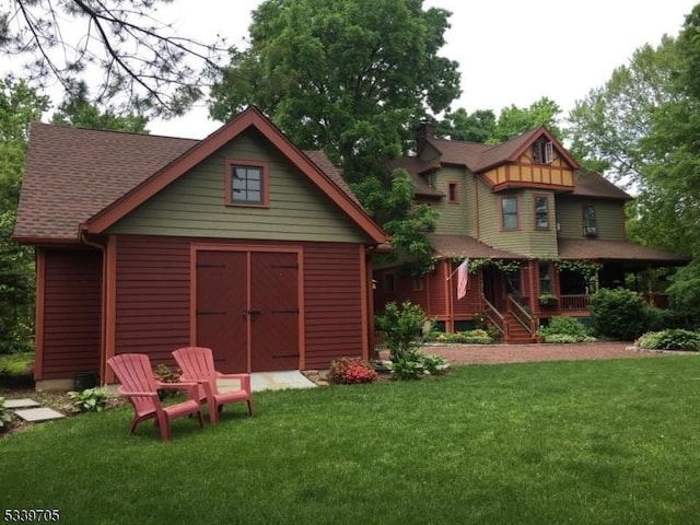 exterior space with covered porch and a yard