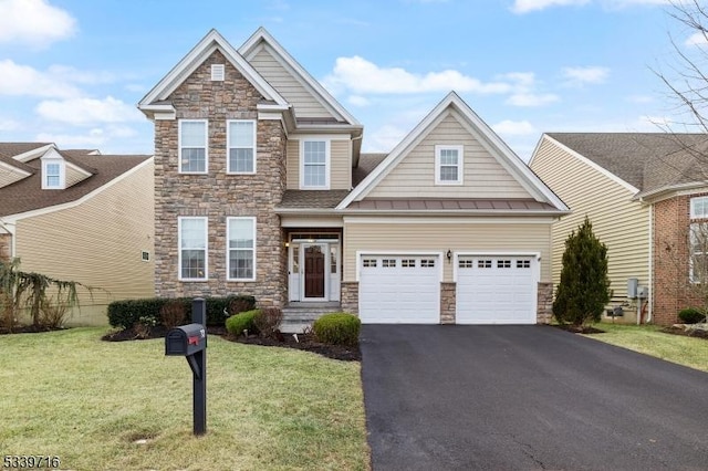 craftsman-style house featuring aphalt driveway, a front yard, stone siding, and a garage