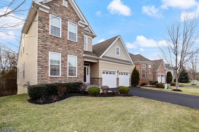 view of front of property with a garage, a front yard, and driveway