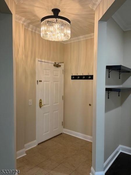 5107 Sanctuary Blvd Unit 5107, Riverdale Boro, NJ 07457 - tiled foyer with a chandelier and ornamental molding