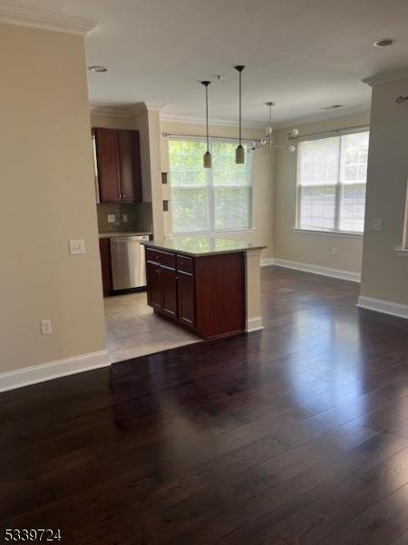 5107 Sanctuary Blvd Unit 5107, Riverdale Boro, NJ 07457 - kitchen featuring stainless steel dishwasher, crown molding, dark wood finished floors, pendant lighting, and backsplash