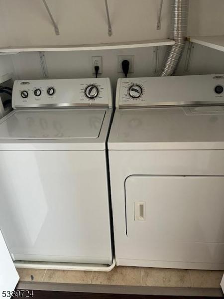 5107 Sanctuary Blvd Unit 5107, Riverdale Boro, NJ 07457 - laundry area with washing machine and clothes dryer and tile patterned floors