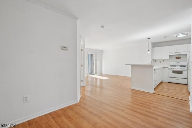 kitchen featuring light countertops, open floor plan, white cabinetry, white range with gas stovetop, and a peninsula