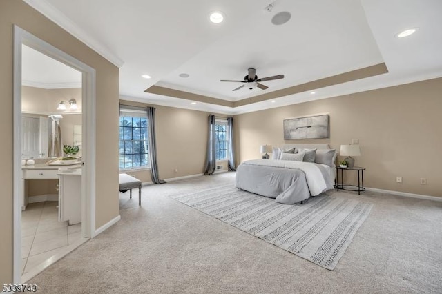 bedroom featuring recessed lighting, a tray ceiling, ornamental molding, and light colored carpet