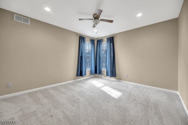 carpeted spare room featuring a ceiling fan, recessed lighting, visible vents, and baseboards