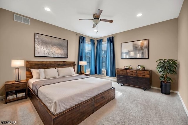 bedroom with recessed lighting, light colored carpet, visible vents, and baseboards