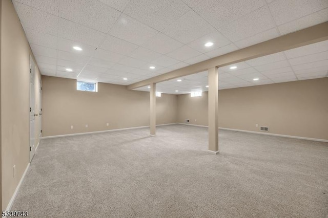 below grade area featuring carpet floors, recessed lighting, visible vents, and baseboards