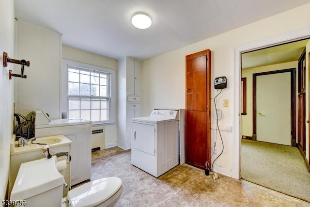 laundry room featuring laundry area, separate washer and dryer, and radiator