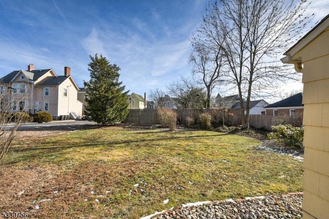 view of yard featuring a residential view and fence