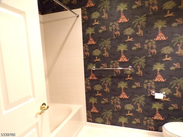 full bath featuring toilet and wallpapered walls