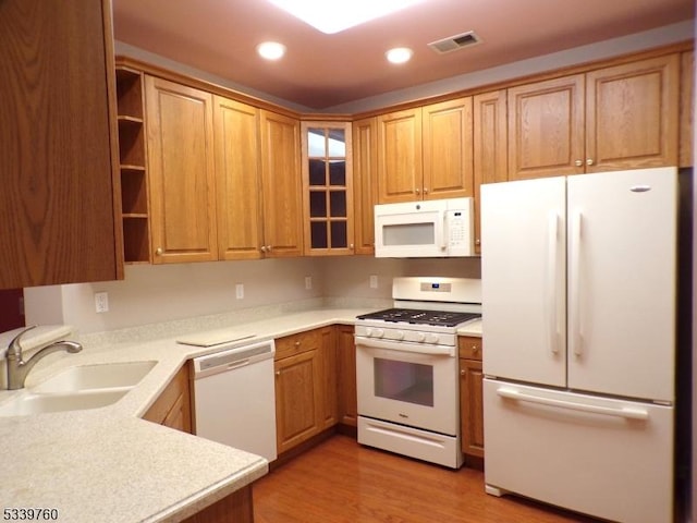 kitchen with white appliances, visible vents, light countertops, a sink, and recessed lighting