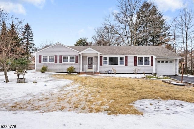 ranch-style home with an attached garage and aphalt driveway