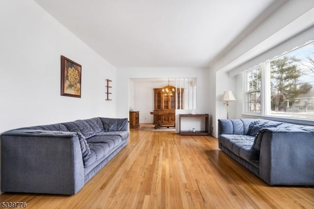 living area with an inviting chandelier and wood finished floors