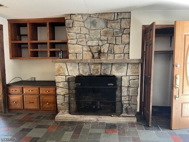 interior details with visible vents and a stone fireplace