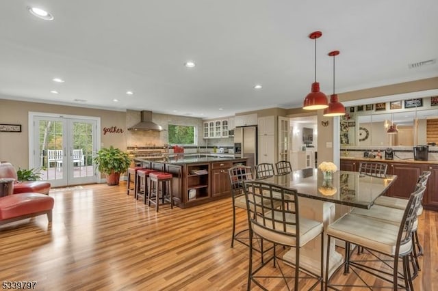 dining space featuring french doors, recessed lighting, visible vents, and light wood-style floors