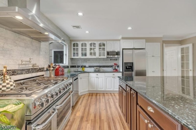 kitchen with glass insert cabinets, brown cabinetry, white cabinetry, and stainless steel appliances