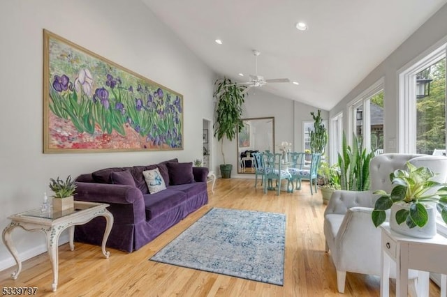 living area with vaulted ceiling, light wood-type flooring, a ceiling fan, and recessed lighting