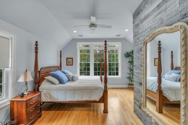 bedroom with visible vents, baseboards, ceiling fan, vaulted ceiling, and light wood-style floors