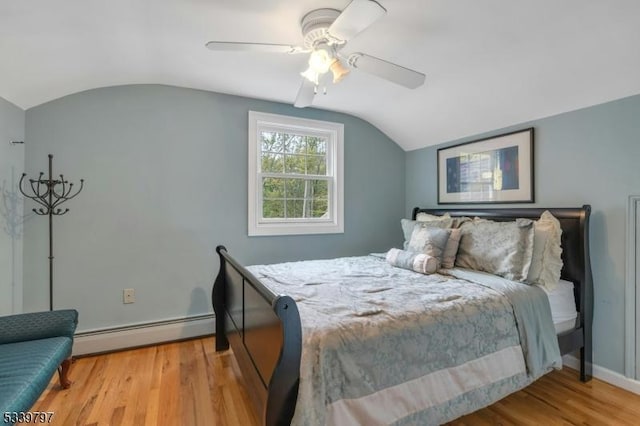 bedroom featuring baseboards, lofted ceiling, ceiling fan, light wood-style floors, and a baseboard heating unit