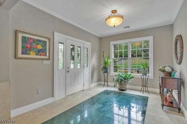 foyer entrance with visible vents, crown molding, baseboards, and light tile patterned floors