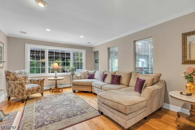 living room with a baseboard heating unit, light wood finished floors, and crown molding