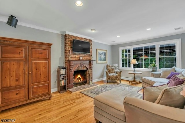 living area featuring light wood-style flooring, a fireplace, visible vents, baseboards, and ornamental molding