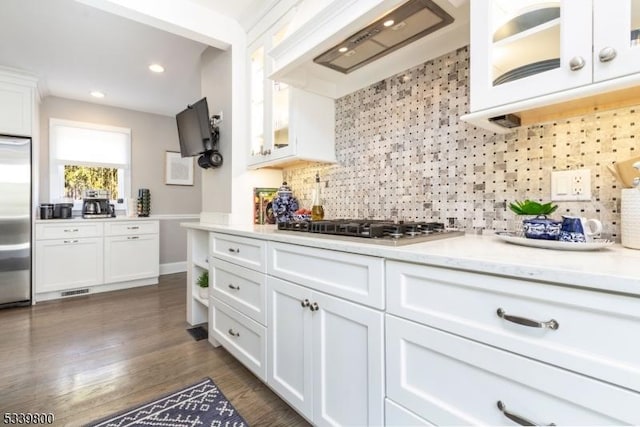 kitchen with stainless steel appliances, white cabinetry, and custom exhaust hood